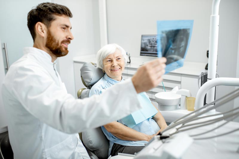 dentist going over scans with dental implant patient